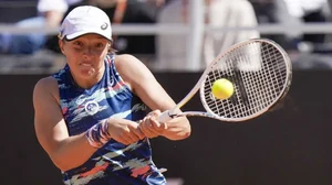Iga Swiatek returns the ball to Bianca Andreescu during their Italian Open tennis match, May 13, 2022.