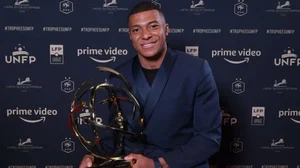 PSGs Kylian Mbappe poses with the Ligue 1s best player award in Paris on Sunday.