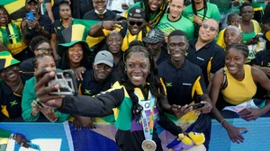 Shericka Jackson celebrates with fans after winning women's 200m at World Athletics Championships.