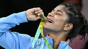 File  : India's Nikhat Zareen bites her boxing gold medal at  Commonwealth Games 2022. 