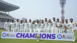 Saurashtra players pose with the trophy for photographs after winning the Ranji Trophy 2022-23, at Eden Gardens in Kolkata.