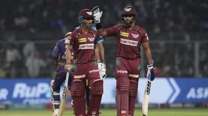 Badoni, left, and Pooran chat mid-innings during their match against KKR on Saturday.