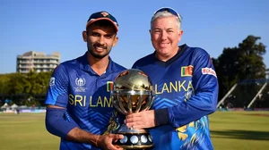 Sri Lanka captain Dasun Shanaka and coach Chris Silverwood pose with the winner's trophy on Sunday.