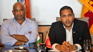 Former Sri Lankan cricketer Sanath Jayasuriya (L) with Sri Lanka Minister of Tourism Harin Fernando. 