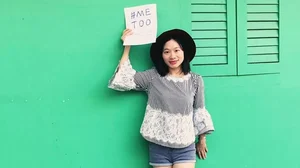 In this photo from 2017, Chinese feminist activist and journalist Huang Xueqin holds up a #MeToo sign. She and fellow activist Wang Jianbing are on a secret trial in China for the incitement of subversion of state power. 