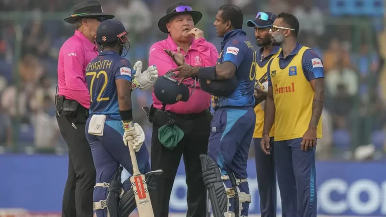 Angelo Mathews (c) talks to the umpires during Sri Lanka's 2023 ODI World Cup tie against Bangladesh. - null