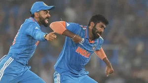 India's Jasprit Bumrah and Virat Kohli celebrate the wicket of Australia's Steve Smith during the ICC Cricket World Cup final match between India and Australia in Ahmedabad.