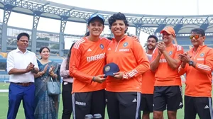 Smriti Mandhana (left) hands Richa Ghosh (right) her maiden Test cap