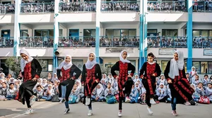 Matching Steps: Palestinian students perform Dabke at the Young Musician Concert organised by the Edward Said National Conservatory of Music at Beit Hanoun Secondary School in Gaza City