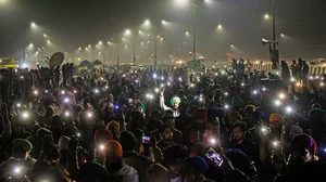 Protestors flash their mobile torches in the memory of 40 farmers who lost their lives during the 2020  protests in Ghaziabad.