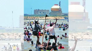  Activists and  residents standing in  the Bay of Bengal  waters, protesting  against the  Kudankulam Atomic  Power Project in  2012 (seen in the  background) 