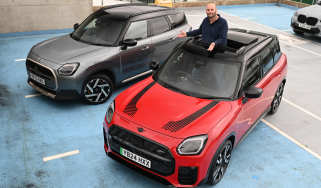 Auto Express creative director Darren Wilson standing with two MINI Countrymans