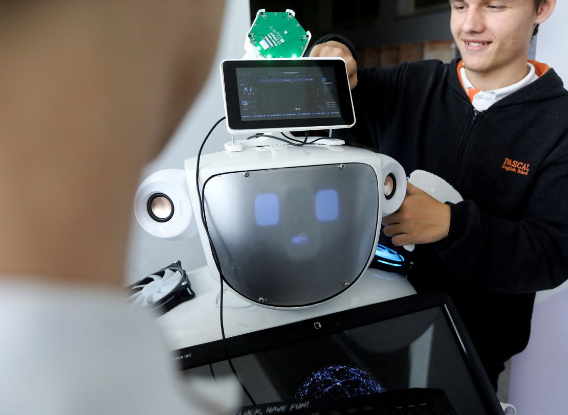 High school students work on "Alnstein", a robot powered by ChatGPT, in Pascal school in Nicosia, Cyprus on March 30, 2023.