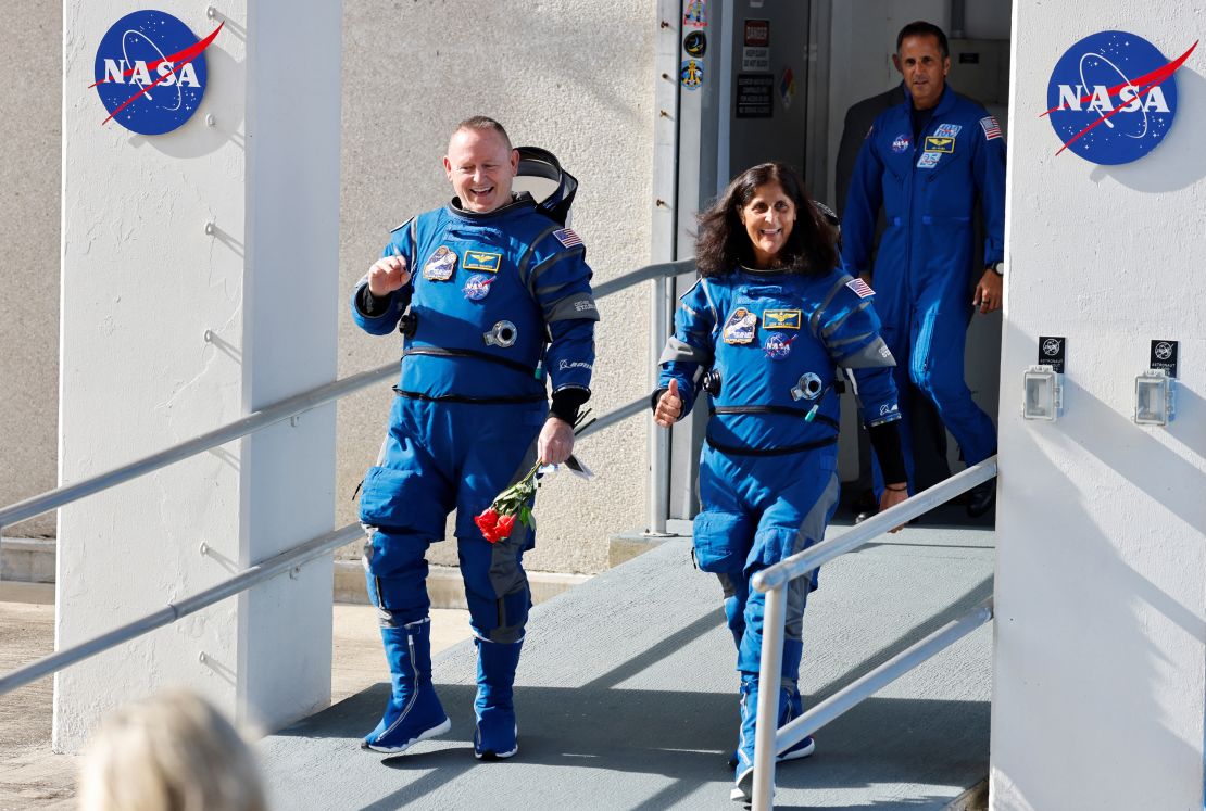 NASA astronauts Butch Wilmore (left) and Suni Williams walk at NASA's Kennedy Space Center in Florida before boarding the Boeing's Starliner spacecraft for the Crew Flight Test mission.