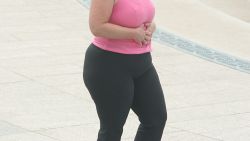 An unidentified woman takes a walk 29 August 2007 in Washington,DC. Two-thirds of US adults and some 25 million children are obese or overweight, and the fatness of the land is harming Americans' health and threatening US competitiveness, a report published 27 August showed. "In the past year, obesity rates have continued to rise in 31 states. Eighty-five percent of Americans believe that obesity is an epidemic," the Trust for America's Health (TFAH) said in its fourth annual "F as in Fat" report. The rate of adult obesity more than doubled in percentage terms in the past 25 years across the United States, growing from 15 percent in 1978-80 to 32 percent in 2003-04, the report said. AFP PHOTO/STR (Photo by STR / AFP) (Photo by STR/AFP via Getty Images)