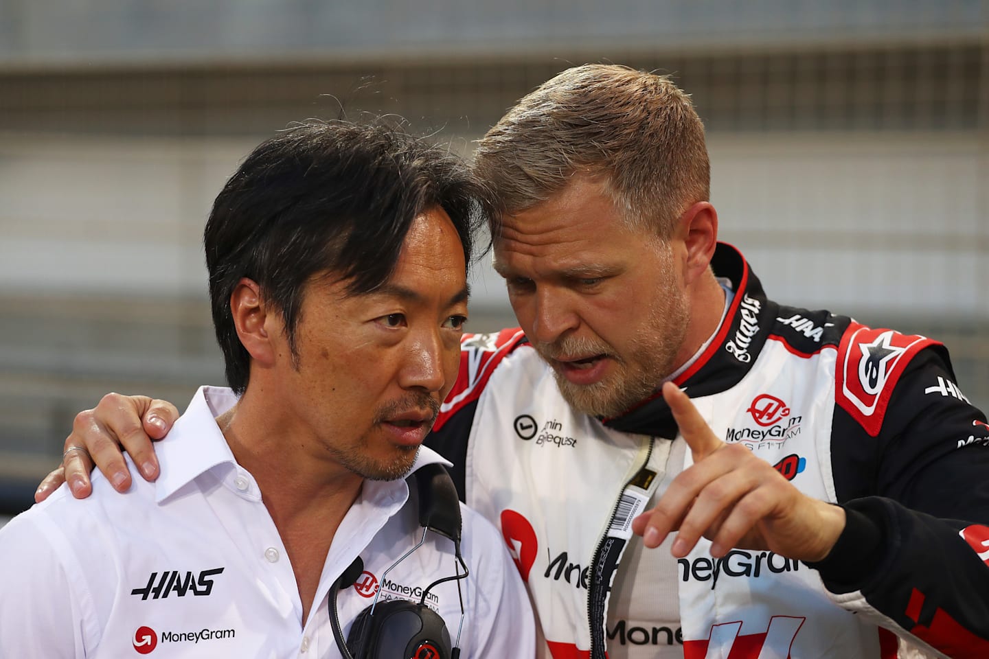 BAHRAIN, BAHRAIN - MARCH 02: Kevin Magnussen of Denmark and Haas F1 talks with Haas F1 Team