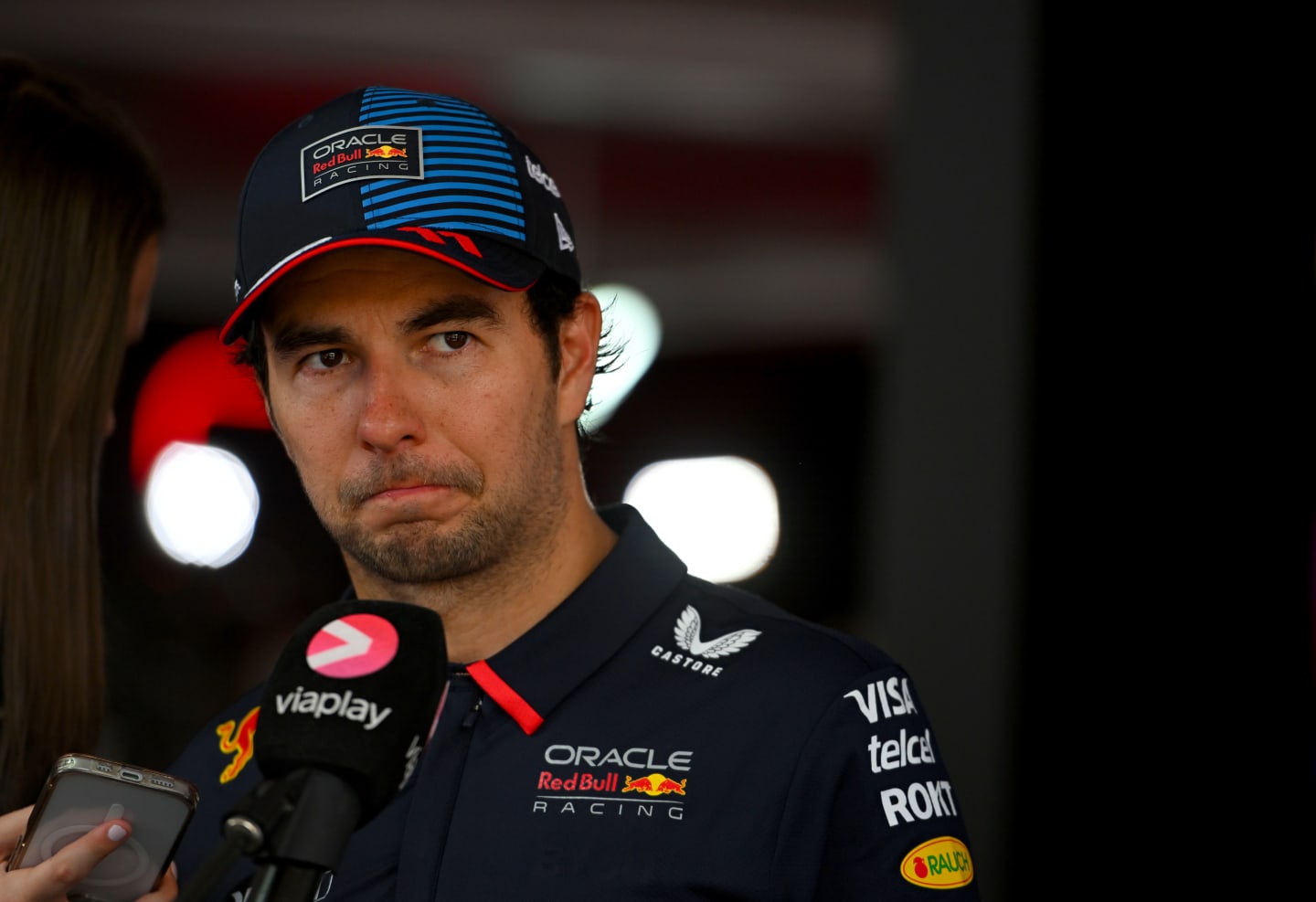 SPIELBERG, AUSTRIA - JUNE 30: 7th placed Sergio Perez of Mexico and Oracle Red Bull Racing talks to