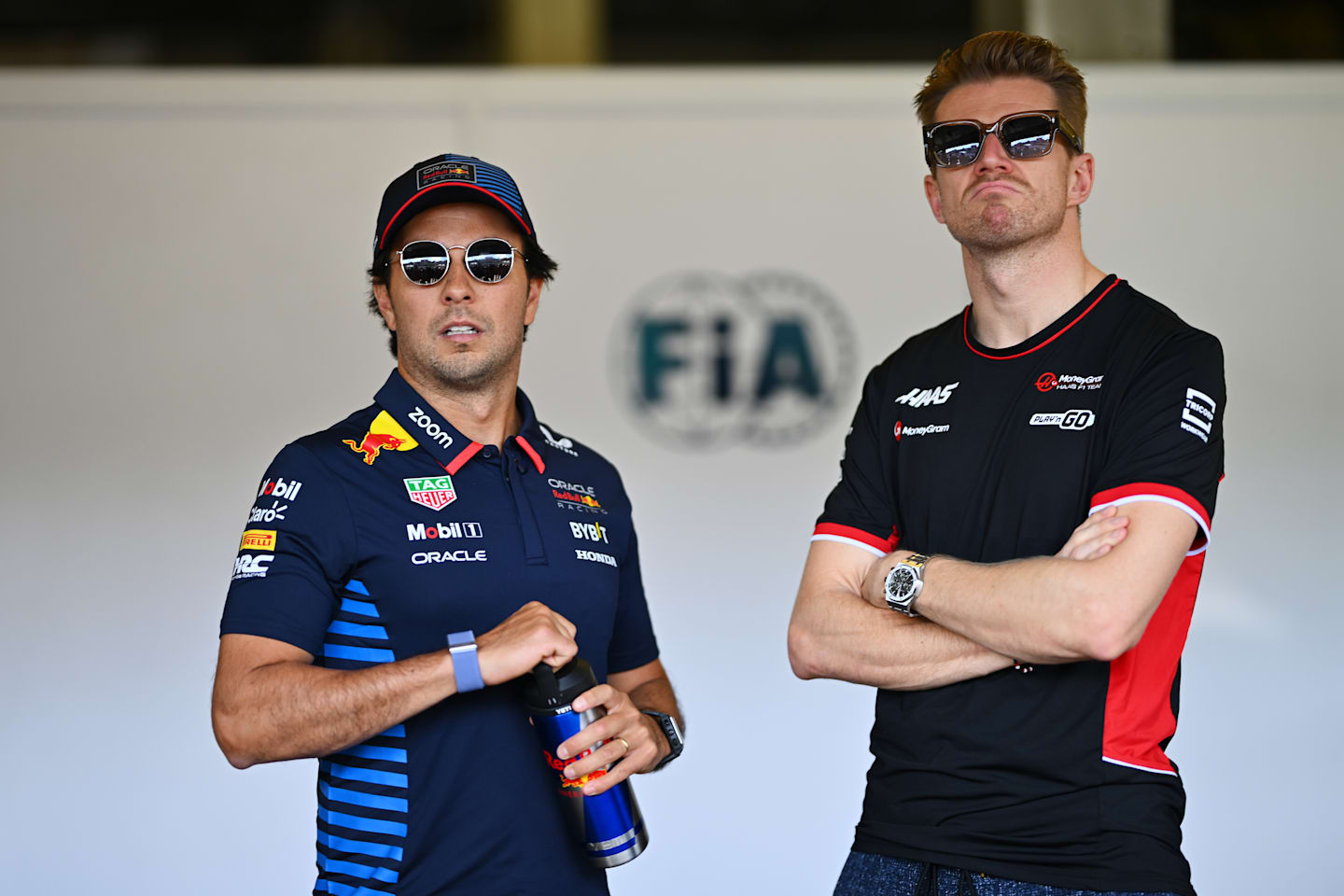 BAKU, AZERBAIJAN - SEPTEMBER 15: Sergio Perez of Mexico and Oracle Red Bull Racing and Nico Hulkenberg of Germany and Haas F1 look on from the FIA garage prior to the F1 Grand Prix of Azerbaijan at Baku City Circuit on September 15, 2024 in Baku, Azerbaijan. (Photo by Dan Mullan/Getty Images)