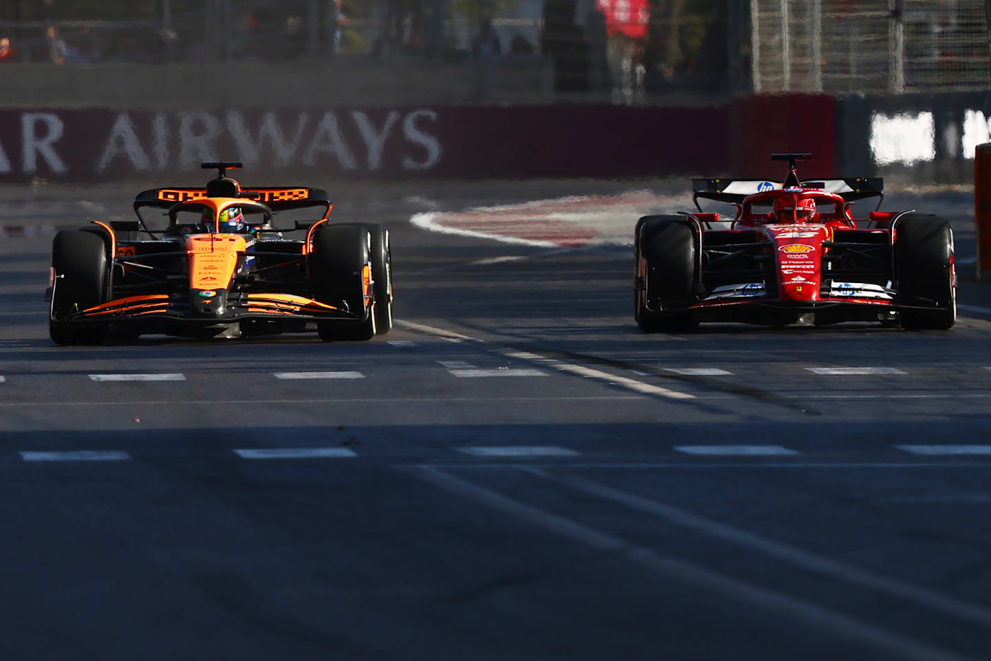 BAKU, AZERBAIJAN - SEPTEMBER 15: Oscar Piastri of Australia driving the (81) McLaren MCL38 Mercedes and Charles Leclerc of Monaco driving the (16) Ferrari SF-24 battle for the lead of the race during the F1 Grand Prix of Azerbaijan at Baku City Circuit on September 15, 2024 in Baku, Azerbaijan. (Photo by Joe Portlock - Formula 1/Formula 1 via Getty Images)