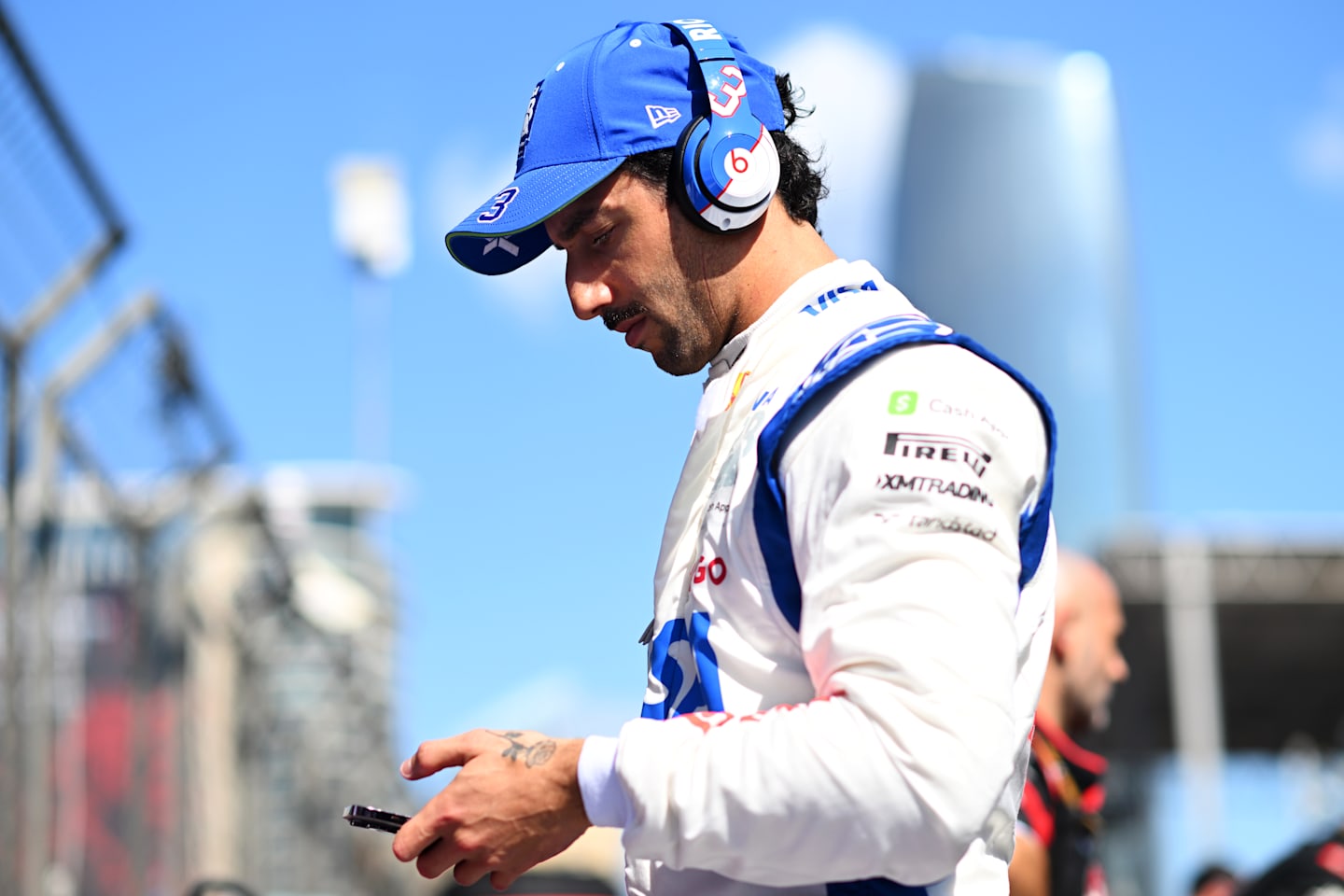 BAKU, AZERBAIJAN - SEPTEMBER 15: Daniel Ricciardo of Australia and Visa Cash App RB looks on, on the grid during the F1 Grand Prix of Azerbaijan at Baku City Circuit on September 15, 2024 in Baku, Azerbaijan. (Photo by Rudy Carezzevoli/Getty Images)