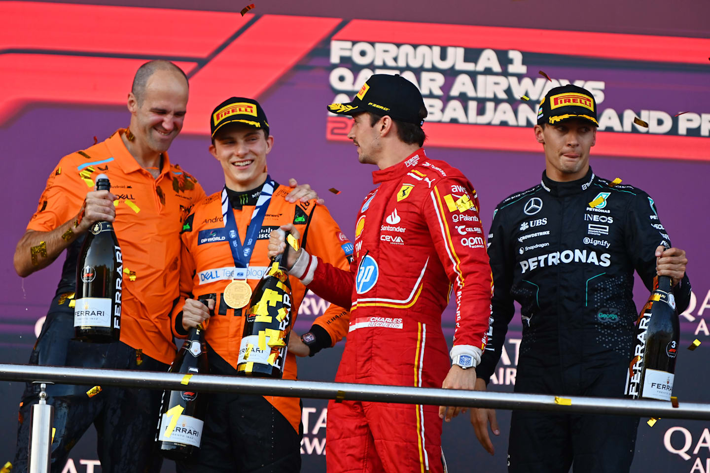 BAKU, AZERBAIJAN - SEPTEMBER 15: Race winner Oscar Piastri of Australia and McLaren, Second placed Charles Leclerc of Monaco and Ferrari, Third placed George Russell of Great Britain and Mercedes and McLaren race engineer Tom Stallard celebrate on the podium during the F1 Grand Prix of Azerbaijan at Baku City Circuit on September 15, 2024 in Baku, Azerbaijan. (Photo by James Sutton/Getty Images)