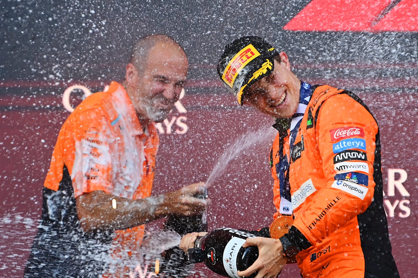 BAKU, AZERBAIJAN - SEPTEMBER 15: Race winner Oscar Piastri of Australia and McLaren and McLaren race engineer Tom Stallard celebrate on the podium during the F1 Grand Prix of Azerbaijan at Baku City Circuit on September 15, 2024 in Baku, Azerbaijan. (Photo by James Sutton/Getty Images)