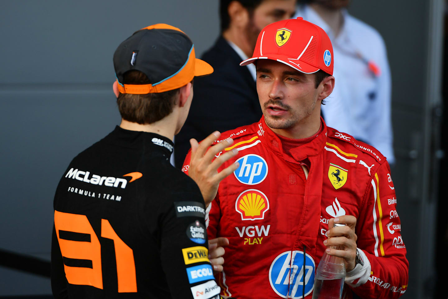 BAKU, AZERBAIJAN - SEPTEMBER 15: Race winner Oscar Piastri of Australia and McLaren and Second placed Charles Leclerc of Monaco and Ferrari talk in parc ferme during the F1 Grand Prix of Azerbaijan at Baku City Circuit on September 15, 2024 in Baku, Azerbaijan. (Photo by James Sutton/Getty Images)