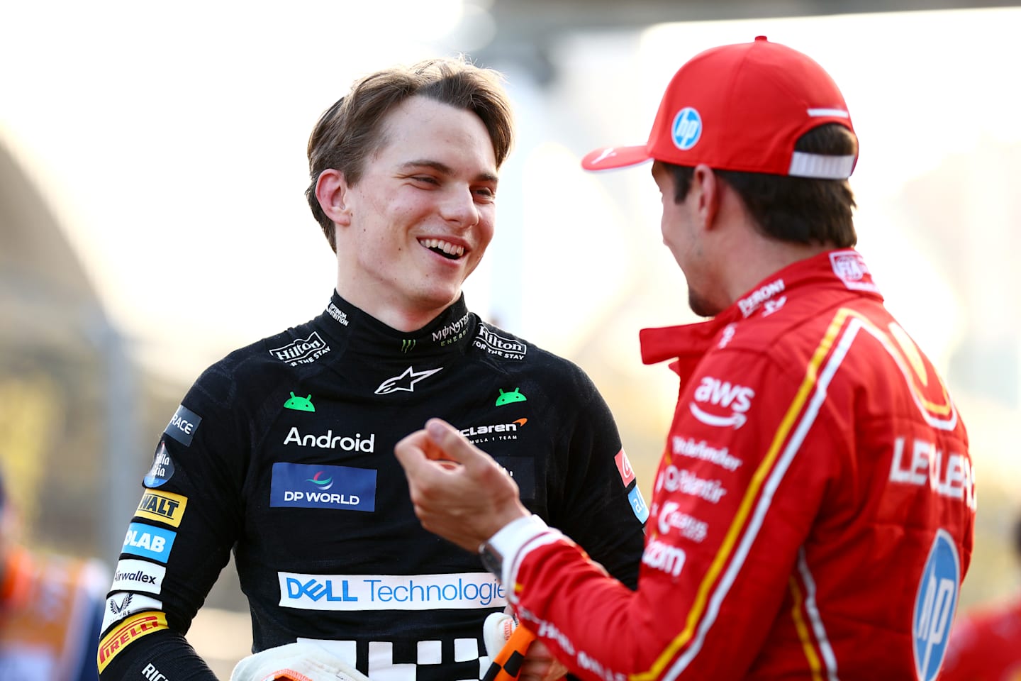 BAKU, AZERBAIJAN - SEPTEMBER 14: Pole position qualifier Charles Leclerc of Monaco and Ferrari talks with Second placed qualifier Oscar Piastri of Australia and McLaren in parc ferme during qualifying ahead of the F1 Grand Prix of Azerbaijan at Baku City Circuit on September 14, 2024 in Baku, Azerbaijan. (Photo by Clive Rose - Formula 1/Formula 1 via Getty Images)