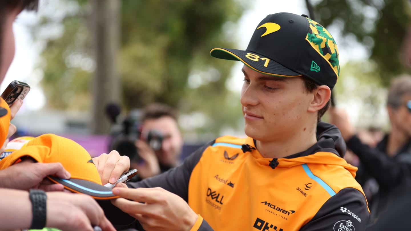 MELBOURNE, AUSTRALIA - MARCH 23: Oscar Piastri of Australia and McLaren F1signs autographs on the