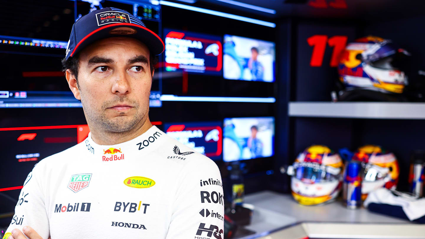 SPA, BELGIUM - JULY 26: Sergio Perez of Mexico and Oracle Red Bull Racing looks on in the garage