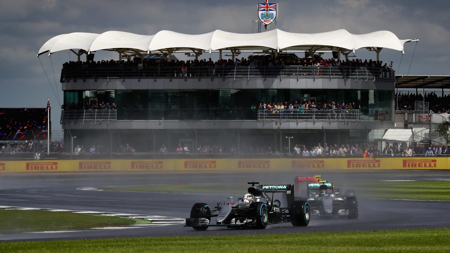 NORTHAMPTON, ENGLAND - JULY 10:  Lewis Hamilton of Great Britain and Mercedes GP leads team mate