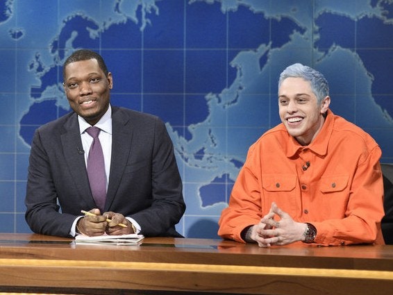 This image may contain Michael Che Pete Davidson Human Person Crowd Sitting Tie Accessories Accessory and Audience