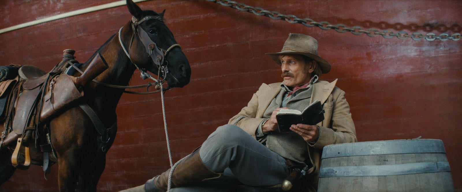 Image may contain Viggo Mortensen Book Publication Clothing Hat Adult Person Animal Horse Mammal and Sitting