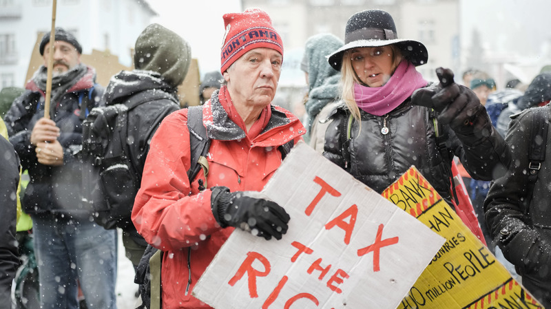 A demonstration at the annual meeting of the World Economic Forum in Davos, Switzerland, in 2023. A perennial Davos topic is how to improve the lives of the world's poor.