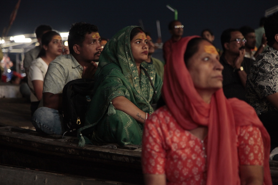 Worshippers and tourists sit on boats facing the bank of the Ganges River in the holy Hindu city of Varanasi to watch the Ganga Aarti, a ritual of devotion to the venerated river. Hindu priests wave fire as the sun sets, ring bells and tap on drums. Thousands watch, clap and chant along from boats crammed in the water.