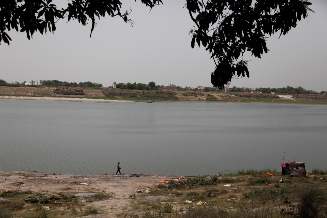 A man walks by the banks of the Ganges River in the town of Chausa in the largely impoverished northern Indian state of Bihar. The ashy remains are from funeral pyres — this is where Hindu residents cremate their loved ones, before submerging their ashes in the river. Residents say here, during the pandemic, as deaths surged, corpses washed up here over a period of six weeks.