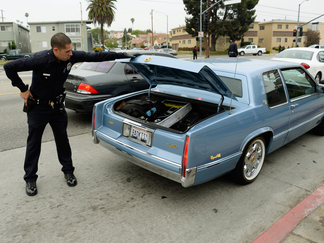 Los Angeles Police Department officers search cars on June 25, 2013.