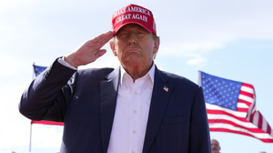 Former President Donald Trump, the Republican presidential candidate, salutes at a campaign rally on March 16 in Vandalia, Ohio.