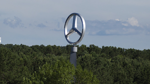 A giant Mercedes-Benz logo towers over the tree line at the Mercedes-Benz U.S. International plant in Vance, Ala., on June 7, 2017.