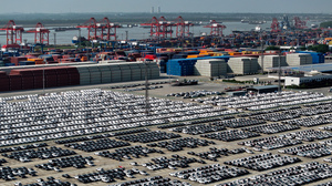 China is aiming to become a global automotive powerhouse, particularly when it comes to electric vehicles. Here, cars wait to be loaded onto a ship at a port in Nanjing.