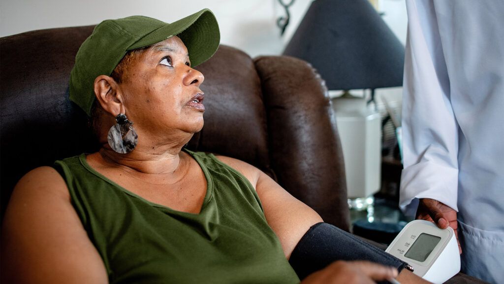 A female sitting in a chair and experiencing hypertension due to low-renin levels -1.