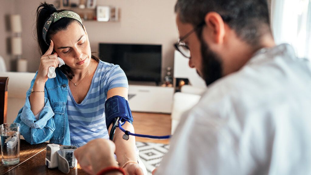 pregnant person checking blood pressure