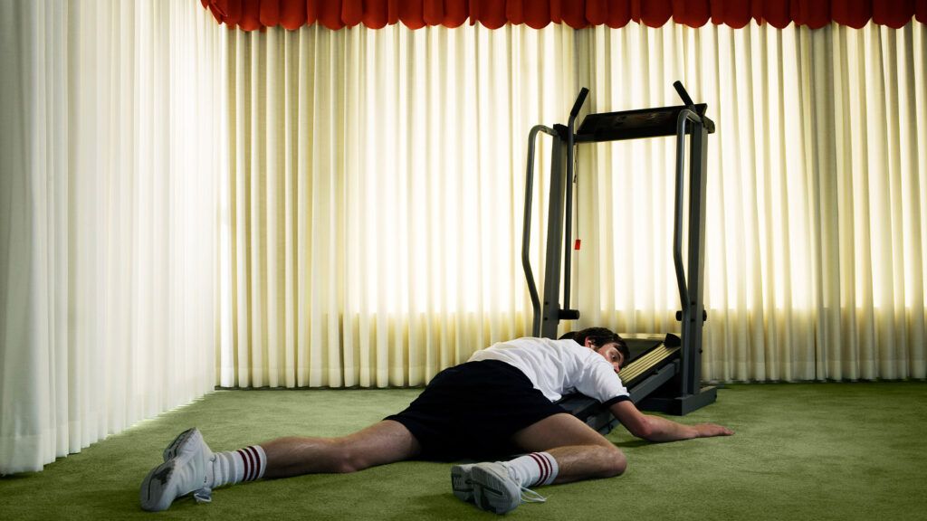 Male lying on a treadmill