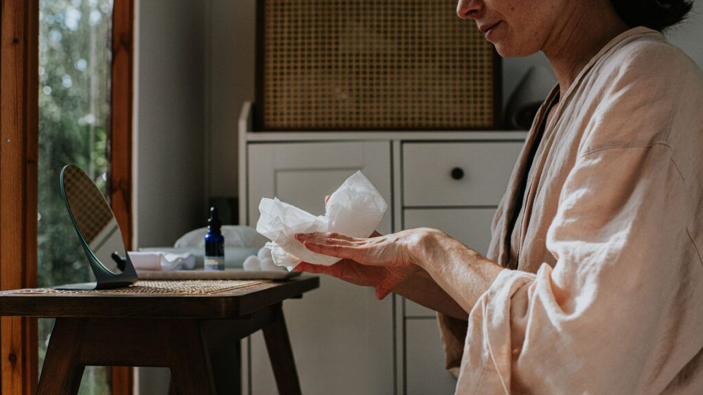 Female putting lotion on her skin