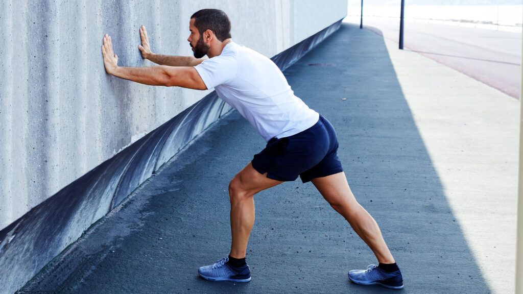 Male stretching his calves outdoors