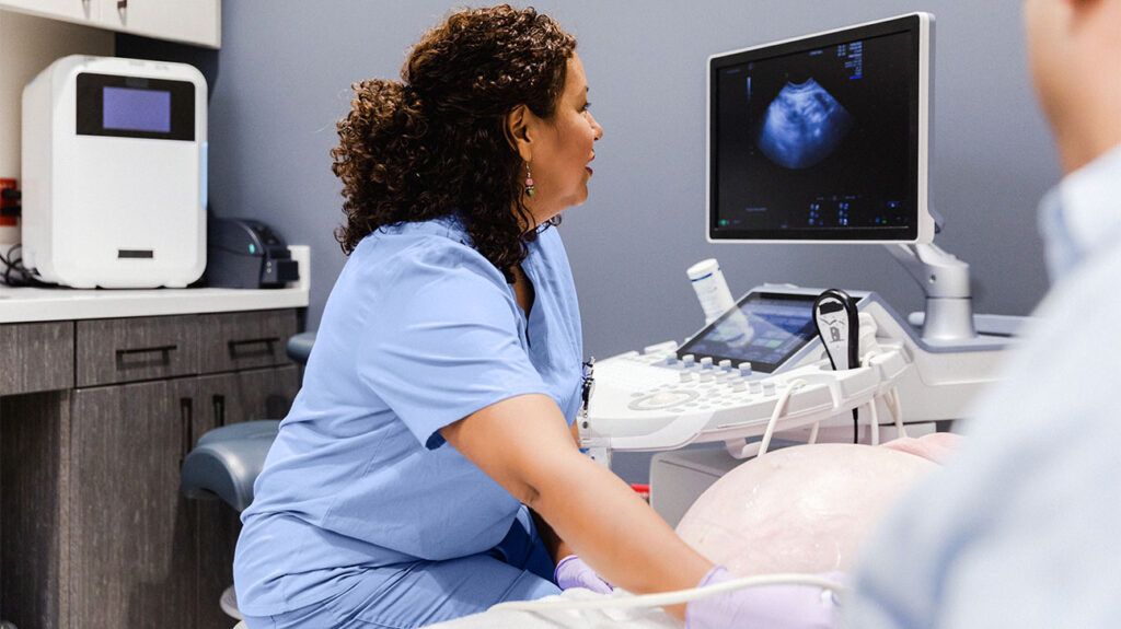 Over-the-shoulder view of an ultrasound technician -2.