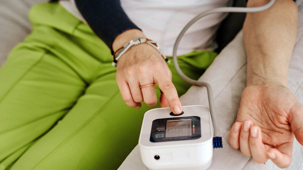 Person measuring their blood pressure