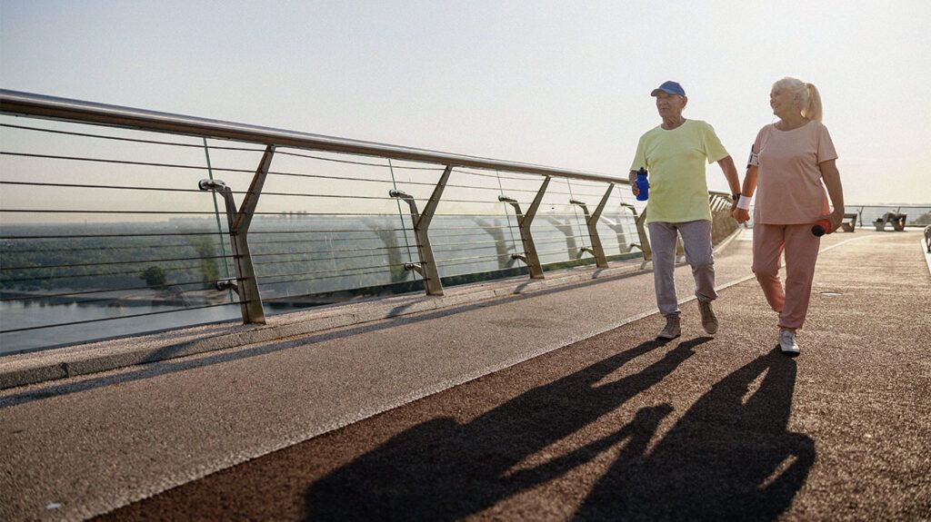 two people doing exercise on a beach front