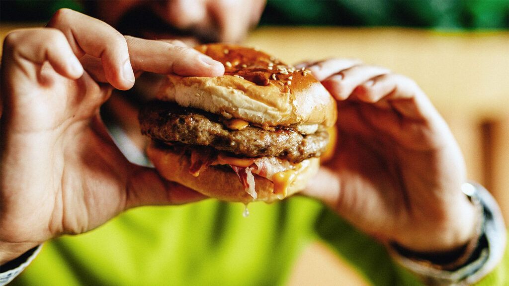 A person holding a burger-2.