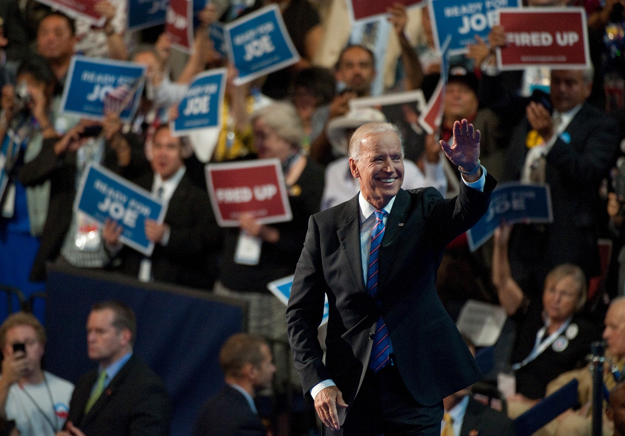 Biden waves onstage in front of a crowd of supporters.